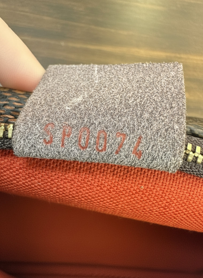 Louis Vuitton
Damier Ebene Trousse Pochette- great gift!