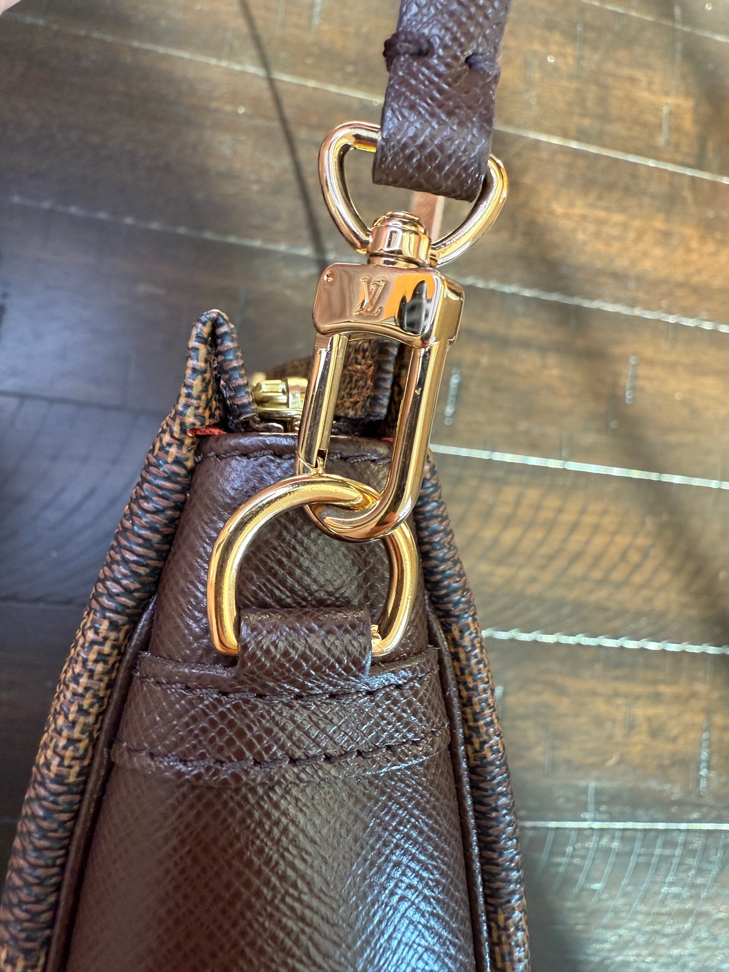 Louis Vuitton
Damier Ebene Trousse Pochette- great gift!