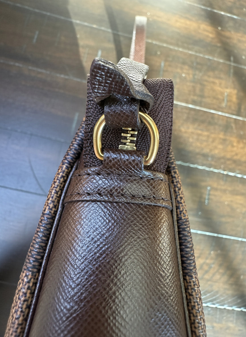 Louis Vuitton
Damier Ebene Trousse Pochette- great gift!